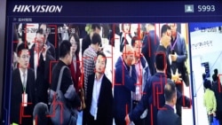 In this photo taken Tuesday, Oct. 23, 2018, visitors are tracked by facial recognition technology from state-owned surveillance equipment manufacturer Hikvision at the Security China 2018 expo in Beijing, China. (AP Photo/Ng Han Guan)