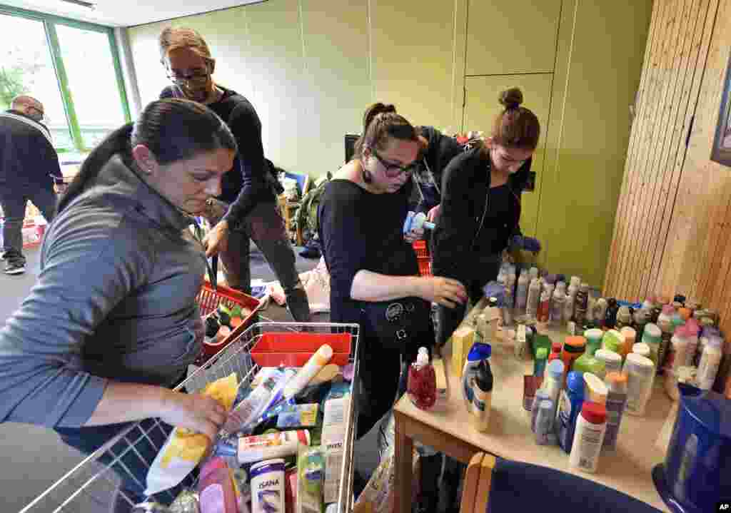 Helpers handling donations for refugees at a hall where the migrants wait for transport to asylum seekers facilities in Dortmund, Germany, Sept. 6, 2015.