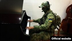 Український воїн-музикант в зоні бойових дій на Донбасі на лінії фронту (ілюстраційне фото)