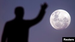 FILE - A full moon rises over the Juscelino Kubitschek Memorial in Brasilia, Brazil. (Reuters)