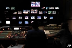 Employees of the Greece state broadcaster ERT in the control room at the television station's headquarters in Athens, June 12, 2013.