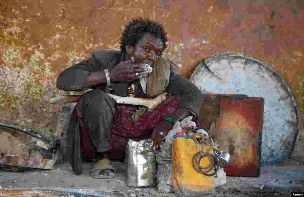 An internally displaced man eats a maize meal from the United Nations World Food Programme (WFP) feeding program at the Sorrdo camp in Hodan district of Somalia&#39;s capital Mogadishu.