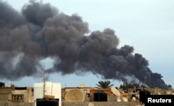 Smoke billows from a factory after an airstrike by forces loyal to former general Khalifa Haftar, in Benghazi, Libya, Oct. 22, 2014.