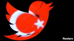 FILE - A Turkish national flag is seen through a broken Twitter logo in a photo illustration taken in Zenica.