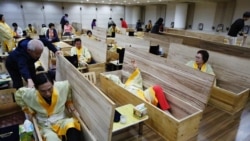 Participants get into coffins during a "living funeral" event as part of a "dying well" program in Seoul, South Korea, October 31, 2019. Picture taken on October 31, 2019. REUTERS/Heo Ran