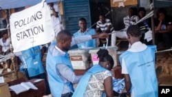 FILE - Election officials count ballot papers cast at a polling station in Freetown, Sierra Leone, March 7, 2018.