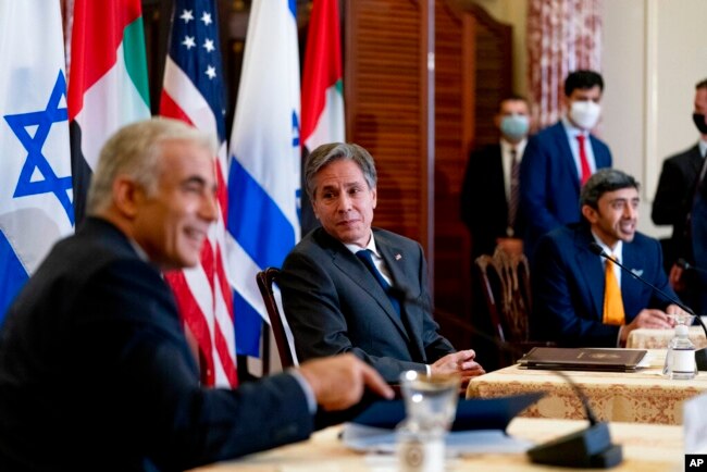 Secretary of State Antony Blinken, Israeli Foreign Minister Yair Lapid, left, and United Arab Emirates Foreign Minister Sheikh Abdullah bin Zayed al-Nahyanin, right, appear at a joint news conference at the State Department in Washington, Oct. 13, 2021.