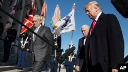 President Donald Trump, joined by Defense Secretary Jim Mattis, left, and Vice President Mike Pence, walks into the Pentagon, Jan. 18, 2018, after speaking to the media.