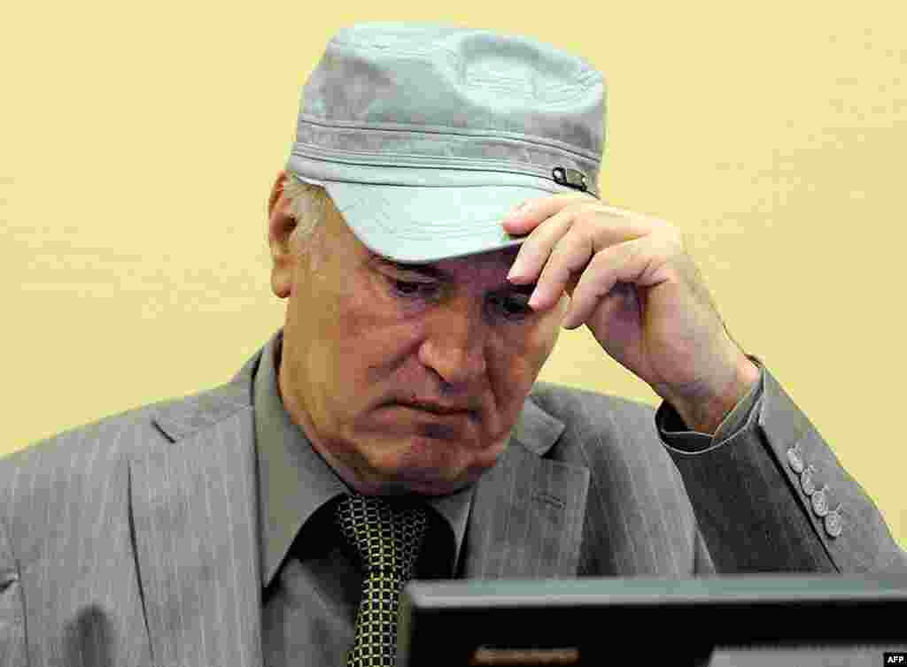 June 3: Former Bosnian Serb Gen. Ratko Mladic removes his hat in the court room during his initial appearance at the U.N.'s Yugoslav war crimes tribunal in The Hague, Netherlands. Mladic told a United Nations war crimes court Friday he is "a gravely ill m