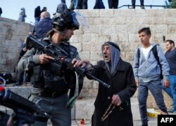 Israeli forces disperse Palestinian protesters outside Damascus Gate in Jerusalem's Old City, Dec. 7, 2017.