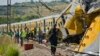 Emergency workers in attendance at the scene of a collision between two passenger trains near Pretoria, South Africa, January 31, 2013.