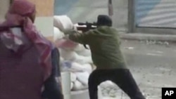 A rebel fires a weapon around a corner at Syrian government forces in Damascus, Syria, December 7, 2012.