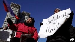 Haitian activists and immigrants protest on City Hall Plaza in Boston, Massachusetts, Jan. 26, 2018. Haitian community leaders complained last week that the Trump administration's delays in re-registering those living in the U.S. legally through the Temporary Protected Status program would lead to job losses, travel problems and other issues for Haitians.