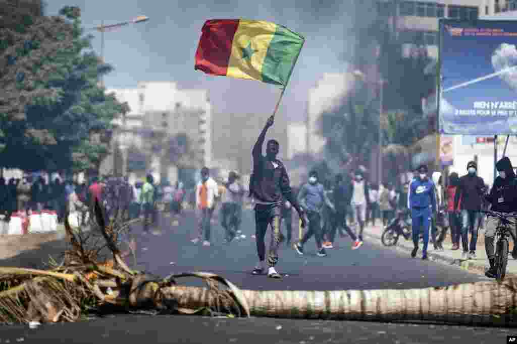 A demonstrator waves a Senegalese national flag during protests in support of main opposition leader and former presidential candidate Ousmane Sonko in Dakar, Senegal.