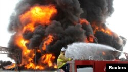 A Palestinian firefighter works during efforts to extinguish a fire at Gaza's main power plant, which witnesses said was hit in Israeli shelling, in the central Gaza Strip, July 29, 2014.