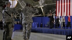 President Barack Obama salutes from stage as he participates in a ceremony at Andrews Air Force Base, Md., Dec. 20, 2011, marking the return of the United States Forces-Iraq Colors and the end of the war in Iraq.