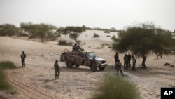 FILE - United Nations peacekeepers patrol on the outskirts of Timbuktu, Mali, July 23, 2013.