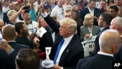 Republican presidential candidate Donald Trump greets the crowd and signs autographs during a campaign rally at the Sharonville Convention Center, July 6, 2016, in Cincinnati, Ohio. 