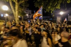 Protesters move the demonstration from the Capitol building to the Governors Mansion, after a warehouse full of relief aid dating back to Hurricane Maria was discovered, in San Juan, Puerto Rico, Jan. 20, 2020.