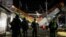 Soldiers stand as rescuers work at a site where an overpass for a metro partially collapsed with train cars on it at Olivos station in Mexico City, Mexico, May 4, 2021. 
