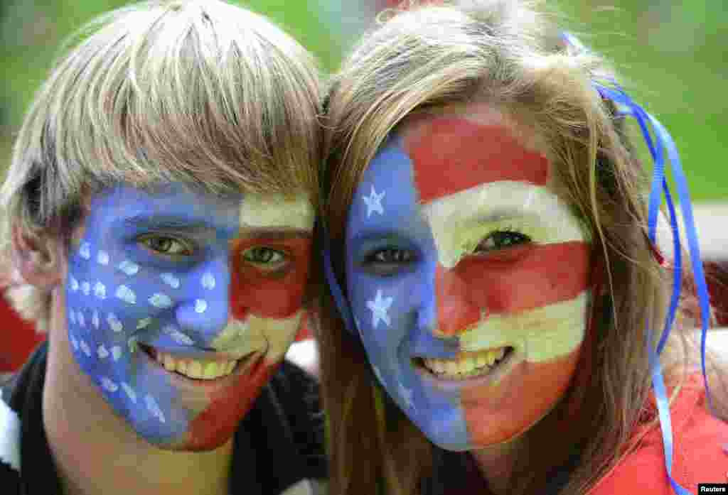 USA fans pose before the women's semi final soccer match against Canada at the London 2012 Olympic Games at Old Trafford in Manchester, August 6, 2012. 