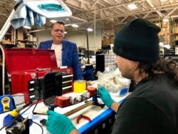 Ted Denney, left, of Synergistic Research of Santa Ana does not agree with Democratic regulations and says he will move his audio company out of California if Katie Porter is re-elected. (Carolyn Presutti, VOA News)