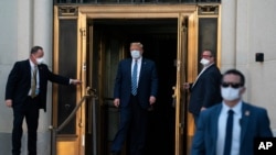 FILE - President Donald Trump walks out of Walter Reed National Military Medical Center after receiving treatment as a COVID-19 patient, in Bethesda, Maryland, Oct. 5, 2020.