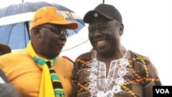 Former Prime Minister Morgan Tsvangirai shares a joke with his former finance minister, Tendai Biti, at a rally of about 500 people in Harare, March 22, 2017. Tsvangirai said the next election is heading for a dispute unless the Zimbabwe Electoral Commiss