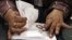 An official counts ballots after polls closed during the final stage of a referendum on Egypt's new constitution in Bani Sweif, about 115 km (71 miles) south of Cairo December 22, 2012.