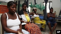 Pregnant women watch television as they wait in the prenatal ward at a maternity hospital in Sierra Leone.