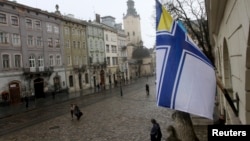 A Ukrainian Naval Forces flag is on display at the city hall building in Lviv, in support of Ukrainian military sailors based in Crimea, March 6, 2014.
