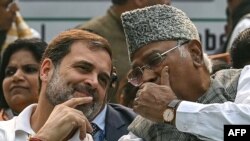 India's Congress party leader Rahul Gandhi (L) talks with party's president Mallikarjun Kharge during a protest in New Delhi on December 22, 2023, against the suspension of lawmakers belonging to an opposition grouping of 26 parties dubbed INDIA -- the In