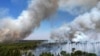 FILE - Smoke rises as fires spread through the Brasilia National Forest, Brazil, in the middle of the dry season, Sept. 3, 2024.