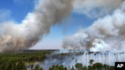 FILE - Smoke rises as fires spread through the Brasilia National Forest, Brazil, in the middle of the dry season, Sept. 3, 2024.