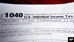 FILE - Part of a 1040 federal tax form printed from the Internal Revenue Service website, Feb. 13, 2019.