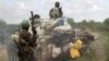 African Union Mission (AMISOM) forces patrol after fighting between insurgents and government soldiers on the outskirts of Mogadishu, Somalia, May 22, 2012. 