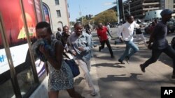 Protesters disperse in Harare Aug. 24, 2016, after Zimbabwe police fired tear gas, water cannon and gunshots to stop hundreds of youths rallying against the government of President Robert Mugabe.