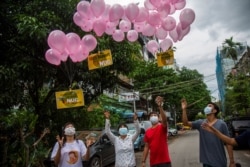 Anti-coup protesters release balloons with posters reading 'We Support NUG,' which stands for 'National Unity Government' during the welcoming NUG balloons campaign on April 17, 2021, in Yangon, Myanmar.