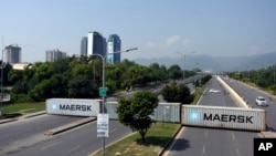 Shipping containers placed by authorities block a key highway to capital city in an attempt to prevent supporters of imprisoned former Prime Minister Imran Khan from holding a rally seeking his release in Islamabad, Pakistan, Oct. 4, 2024.