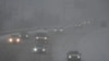 Vehicles drive along a highway during a winter storm, Jan. 5, 2025, in Cincinnati. 