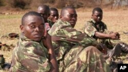 Soldiers with the Armed Forces for the Defense of Mozambique rest after finishing the Marine Combat Fitness Test in Moamba, Mozambique.