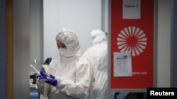 A medical worker wears protective equipment in the COVID-19 testing center at Duesseldorf Airport, Duesseldorf, Germany, Dec. 21, 2020.