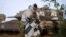 FILE - An Israeli soldier prays in front of a tank at a staging area near Israel's border with the Gaza Strip, in southern Israel,  Dec. 30, 2008.