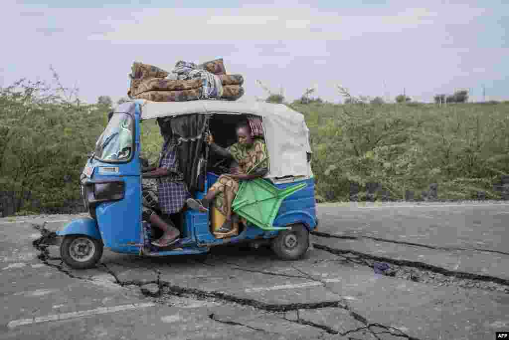 Residents ride a tuk-tuk taxi along a road damaged by multiple earthquakes near the town of Kabanna.&nbsp;Evacuations and displacement are underway in Ethiopia after a series of earthquakes rocked the remote north of the Horn of Africa nation. The earthquakes have damaged houses and threatened to trigger a volcanic eruption of the previously dormant Mount Dofan, near Segento in the northeast Afar region.