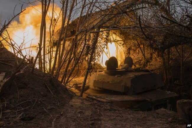 A Ukrainian self-propelled artillery vehicle Gvozdika fires toward Russian positions on the frontline in the Donetsk region, Ukraine, Feb. 16, 2024.