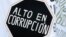 A demonstrator holds a placard that reads "High in corruption" during a rally called by students to protest against government education reforms in Valparaiso city, Chile, June 15, 2016.