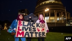 New Zealand protesters hold a vigil against the killing of Minneapolis man George Floyd in a Black Lives Matter protest outside Parliament in Wellington, June 1, 2020. 