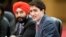 Canadian Prime Minister Justin Trudeau, right, speaks to Chinese Premier Li Keqiang during a meeting at the Great Hall of the People in Beijing, Dec. 4, 2017. 