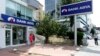 Customers use an ATM machine at a branch of Bank Asya in Ankara, Turkey, Aug. 12, 2014.