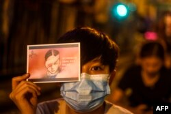 A pro-democracy protester holds a sign while attending a rally in Hong Kong Aug. 16, 2019.